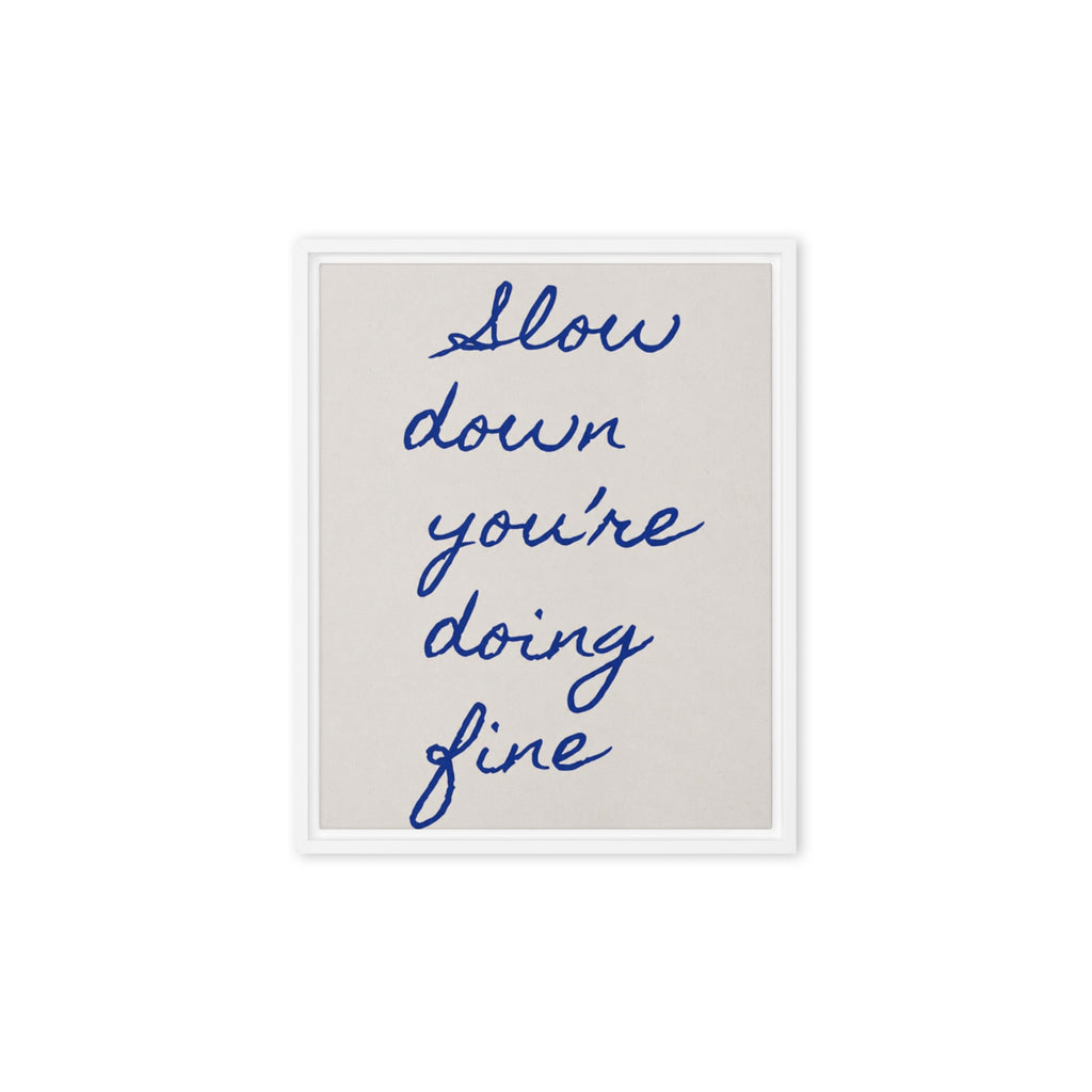 Framed canvas with handwritten navy blue quote "Slow down you're doing fine" on beige background, white pine wood floating frame / Картина с рамка с ръкописен цитат „Забави се, справяш се добре" в тъмносиньо на бежов фон, бяла плаваща рамка